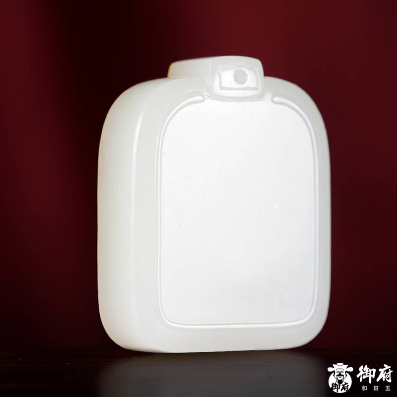 Side profile showing the 9.5 millimetre thickness of a Hetian jade peace plaque